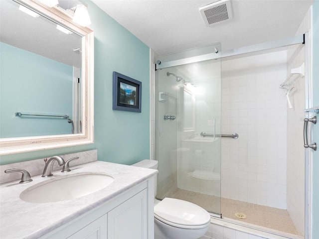 full bathroom with visible vents, toilet, a shower stall, and vanity