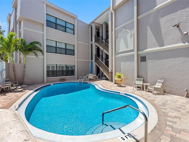 community pool with a patio area