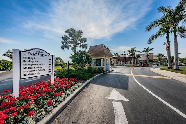 5108 Brittany Dr S Unit 607, Saint Petersburg, FL 33715 - view of asphalt road featuring curbs and a gated entry