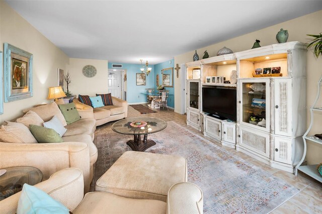 5108 Brittany Dr S Unit 607, Saint Petersburg, FL 33715 - tiled living room featuring a chandelier