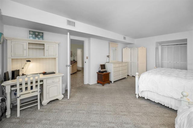 5108 Brittany Dr S Unit 607, Saint Petersburg, FL 33715 - bedroom featuring light carpet, an office area, and a closet