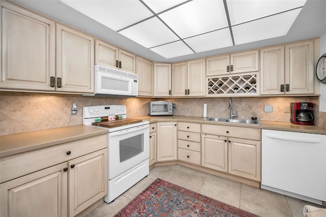 5108 Brittany Dr S Unit 607, Saint Petersburg, FL 33715 - kitchen with white appliances, a sink, and cream cabinets