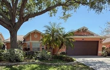 965 Westwinds Blvd, Tarpon Springs, FL 34689 - view of front of home with concrete driveway and a garage