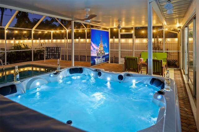 1698 Eden Ct, Clearwater, FL 33756 - pool at night with glass enclosure, an outdoor hot tub, and ceiling fan