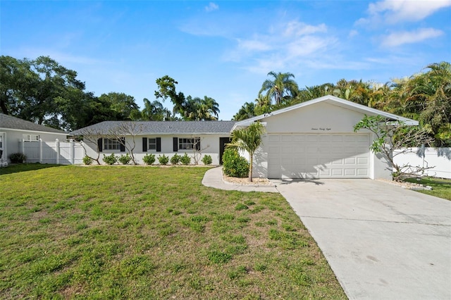 1698 Eden Ct, Clearwater, FL 33756 - ranch-style house with fence, stucco siding, driveway, a front yard, and a garage