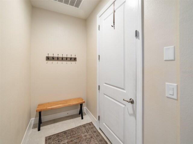 interior space featuring visible vents, tile patterned floors, and baseboards