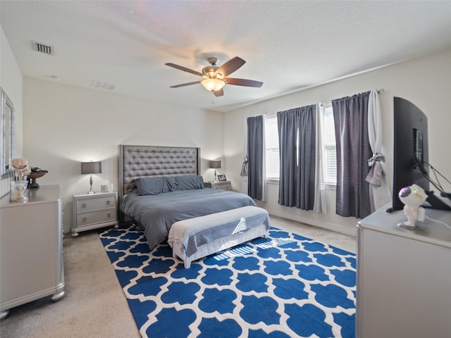 bedroom featuring visible vents, a ceiling fan, and carpet