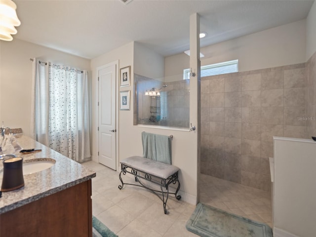 bathroom with tile patterned floors, vanity, and walk in shower