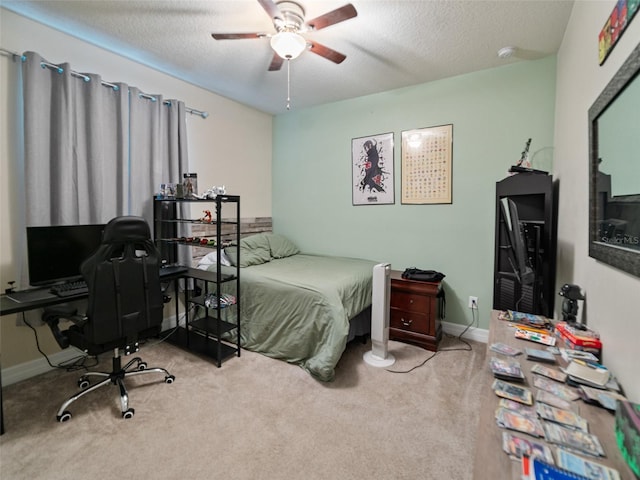 bedroom featuring carpet, a textured ceiling, baseboards, and ceiling fan