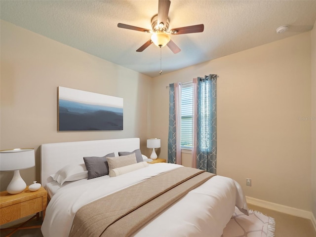 bedroom with baseboards, ceiling fan, and a textured ceiling