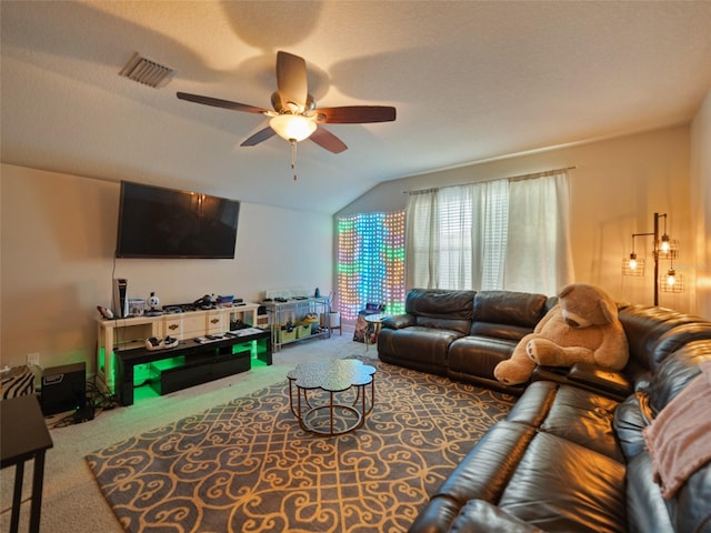 living room with visible vents, vaulted ceiling, a ceiling fan, and carpet floors