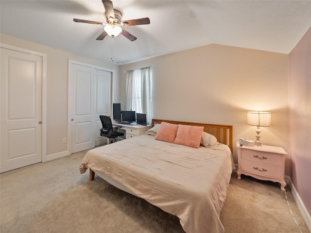 bedroom featuring light carpet, baseboards, vaulted ceiling, and ceiling fan