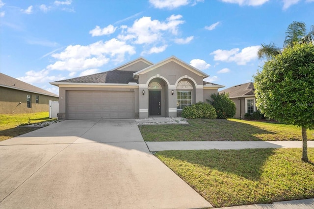 ranch-style home with concrete driveway, stucco siding, an attached garage, and a front lawn
