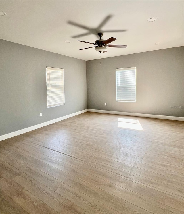 1002 E N Bay St, Tampa, FL 33603 - unfurnished room with wood finished floors, a ceiling fan, and baseboards