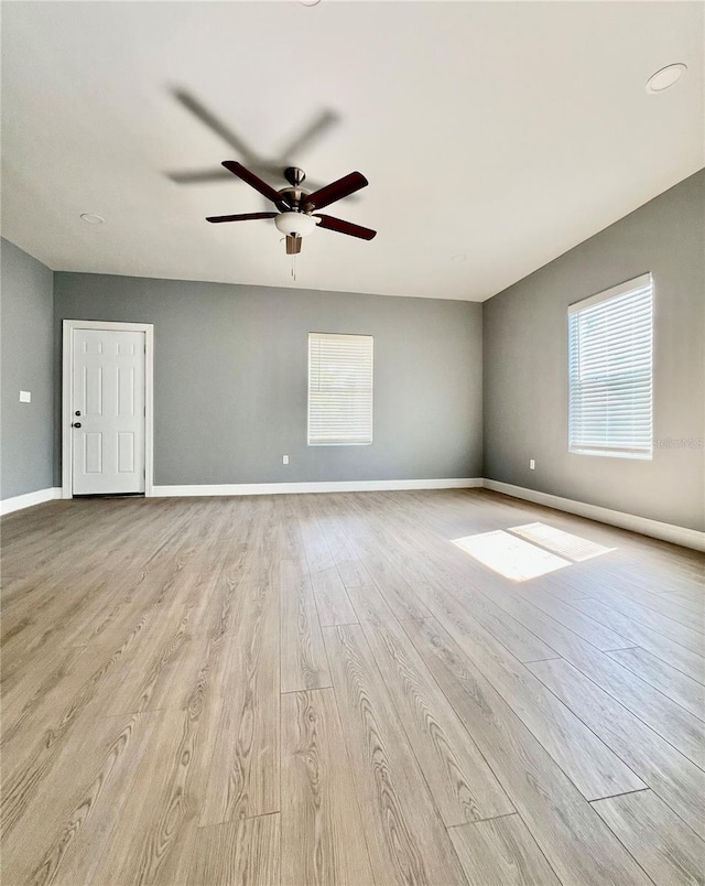 1002 E N Bay St, Tampa, FL 33603 - empty room with ceiling fan, light wood-type flooring, and baseboards