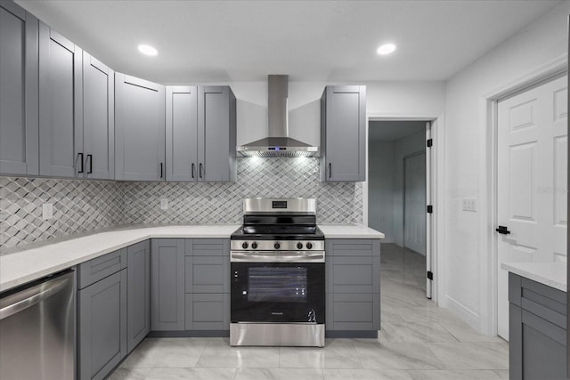 4175 N Concord Dr, Crystal River, FL 34428 - kitchen with gray cabinets, wall chimney range hood, and stainless steel appliances