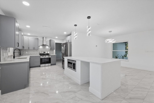4175 N Concord Dr, Crystal River, FL 34428 - kitchen featuring gray cabinetry, wall chimney exhaust hood, appliances with stainless steel finishes, marble finish floor, and a sink