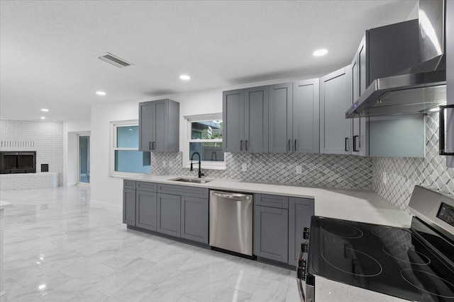 4175 N Concord Dr, Crystal River, FL 34428 - kitchen featuring visible vents, wall chimney exhaust hood, decorative backsplash, stainless steel appliances, and a sink