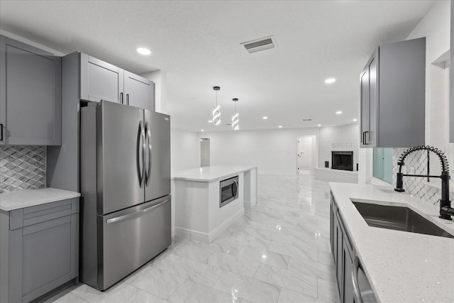 4175 N Concord Dr, Crystal River, FL 34428 - kitchen with backsplash, visible vents, appliances with stainless steel finishes, marble finish floor, and a sink