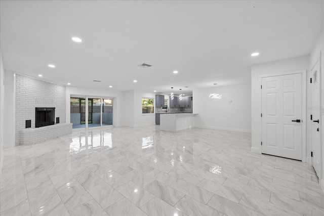 4175 N Concord Dr, Crystal River, FL 34428 - unfurnished living room with recessed lighting, a fireplace, marble finish floor, and baseboards