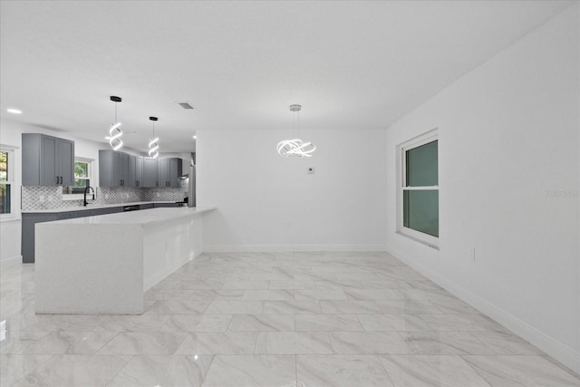 4175 N Concord Dr, Crystal River, FL 34428 - kitchen featuring light countertops, gray cabinetry, visible vents, decorative backsplash, and marble finish floor