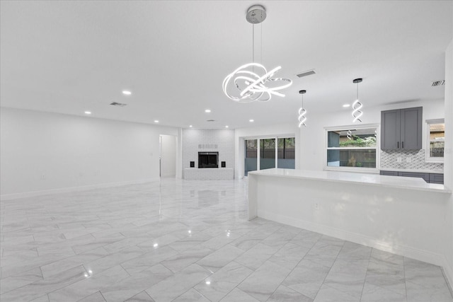 4175 N Concord Dr, Crystal River, FL 34428 - unfurnished living room with visible vents, recessed lighting, marble finish floor, and an inviting chandelier