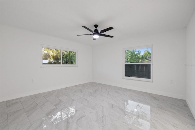 4175 N Concord Dr, Crystal River, FL 34428 - empty room with ceiling fan, baseboards, and a healthy amount of sunlight