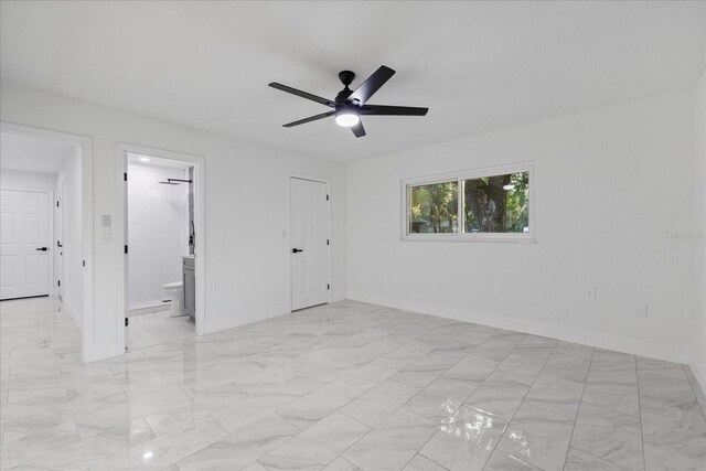 4175 N Concord Dr, Crystal River, FL 34428 - unfurnished bedroom with baseboards, a ceiling fan, and connected bathroom