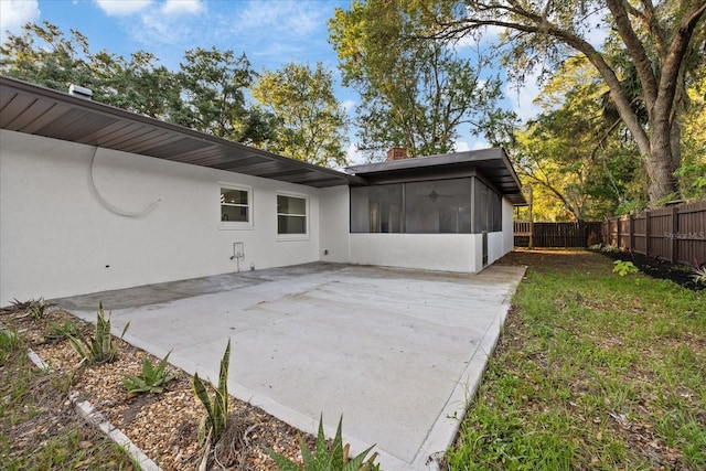 4175 N Concord Dr, Crystal River, FL 34428 - rear view of property featuring a sunroom, a patio area, a fenced backyard, and stucco siding