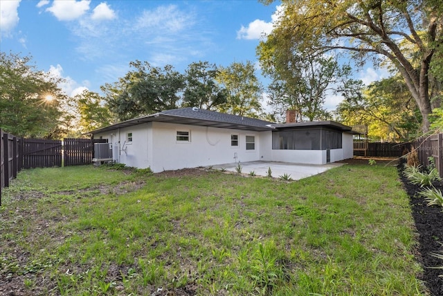4175 N Concord Dr, Crystal River, FL 34428 - back of property with a sunroom, a patio area, a lawn, a fenced backyard, and stucco siding