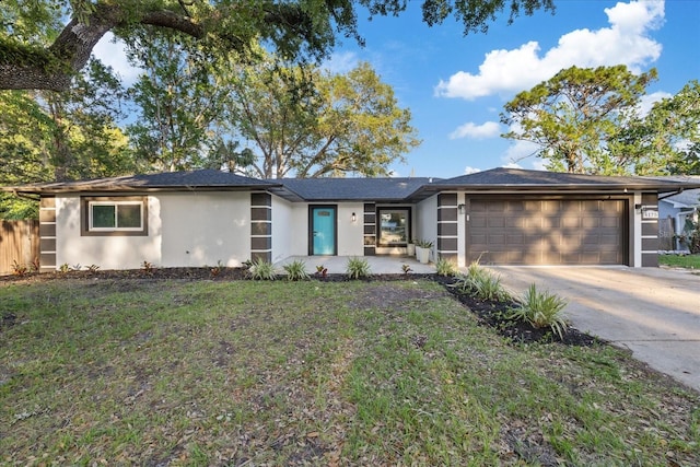 4175 N Concord Dr, Crystal River, FL 34428 - view of front of house with a garage, stucco siding, concrete driveway, and a front lawn