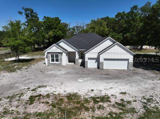 18483 Purple Creek Ln Lot 1, Lutz, FL 33549 - view of front of home featuring board and batten siding and a garage