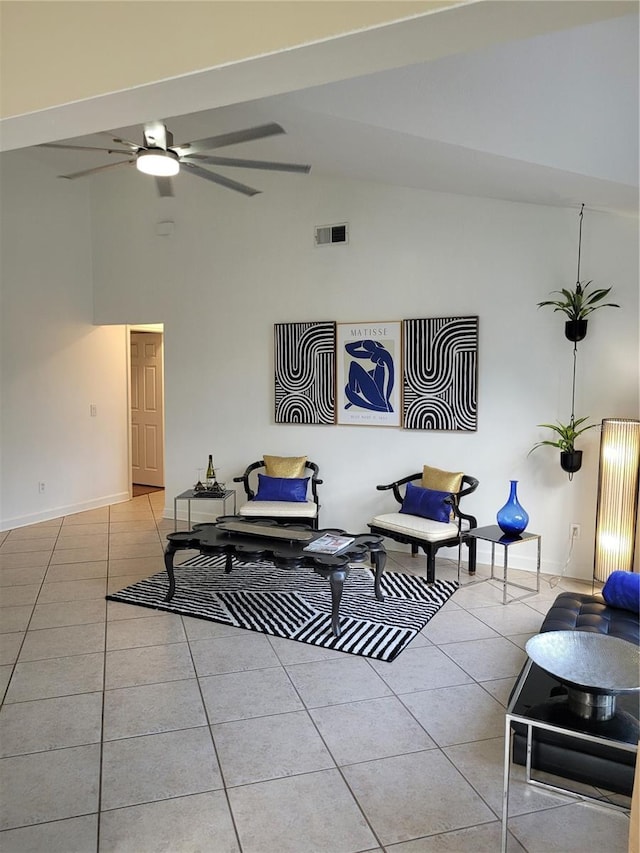 living area featuring high vaulted ceiling, light tile patterned floors, a ceiling fan, visible vents, and baseboards