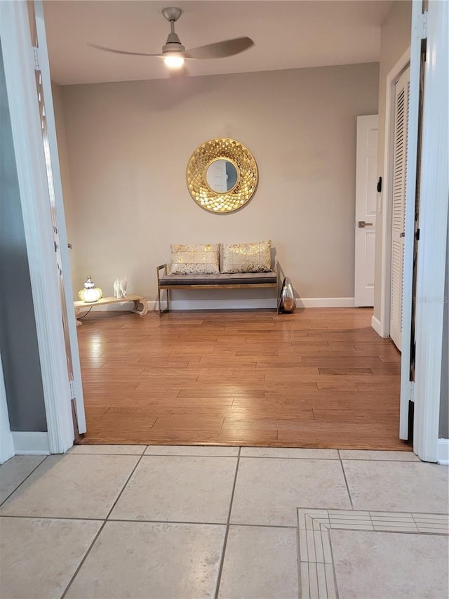 hall with tile patterned floors and baseboards