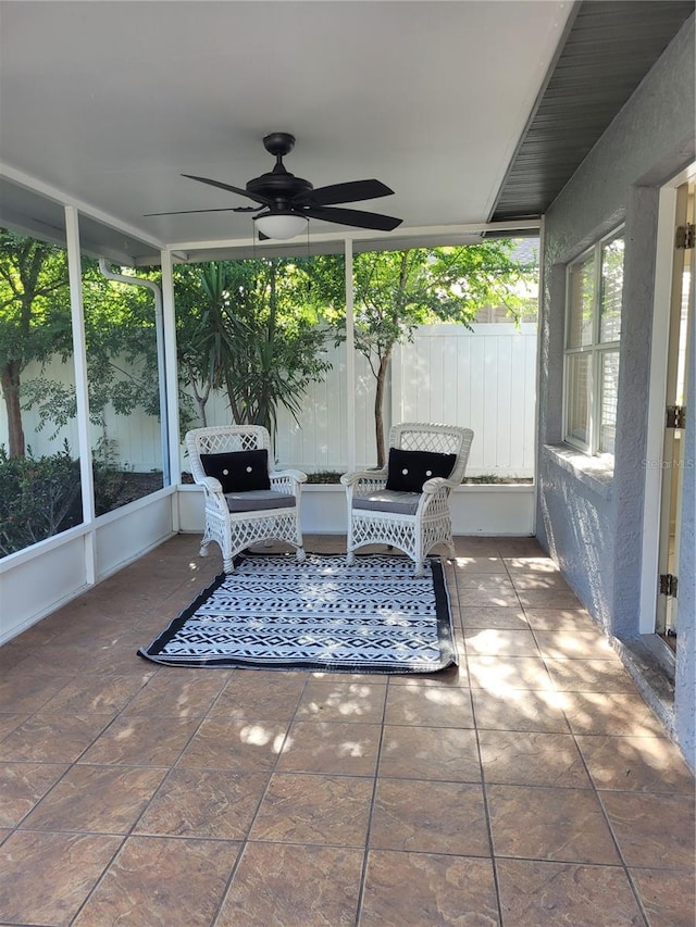 view of patio with ceiling fan and fence