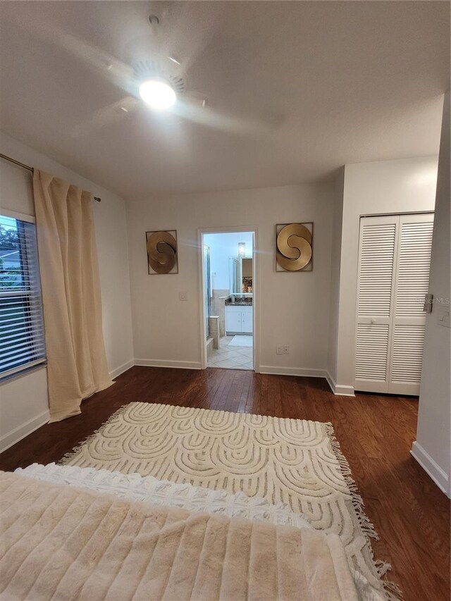824 Greenbelt Cir, Brandon, FL 33510 - unfurnished bedroom featuring wood finished floors, ensuite bath, and ceiling fan