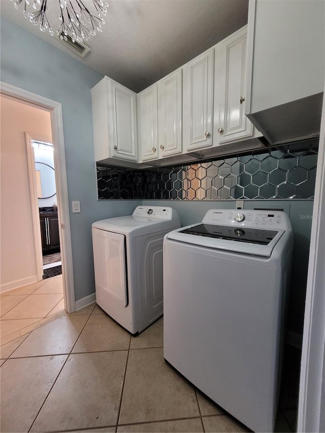 824 Greenbelt Cir, Brandon, FL 33510 - laundry area featuring washer and clothes dryer, cabinet space, and light tile patterned floors