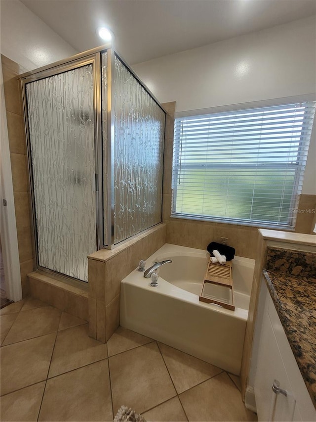 824 Greenbelt Cir, Brandon, FL 33510 - full bathroom with tile patterned flooring, a bath, a shower stall, and vanity