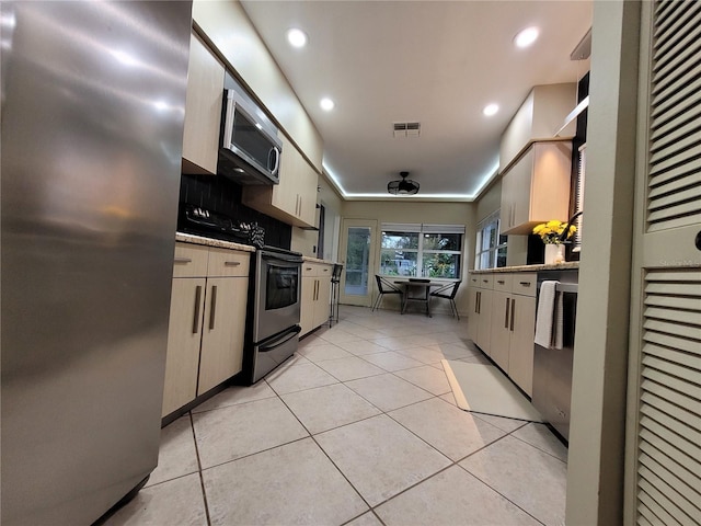 824 Greenbelt Cir, Brandon, FL 33510 - kitchen featuring stainless steel appliances, light tile patterned floors, recessed lighting, tasteful backsplash, and light stone countertops