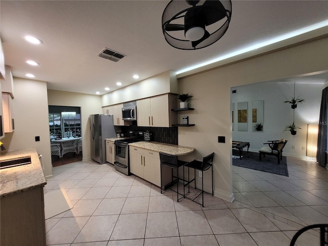 824 Greenbelt Cir, Brandon, FL 33510 - kitchen featuring stainless steel appliances, light tile patterned flooring, recessed lighting, white cabinetry, and open shelves