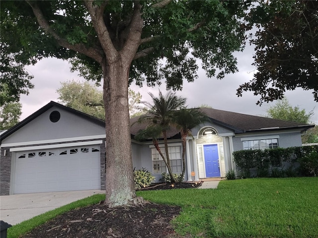 824 Greenbelt Cir, Brandon, FL 33510 - single story home featuring a front lawn, a garage, stucco siding, driveway, and roof with shingles