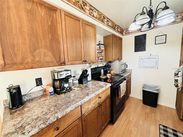 kitchen featuring black range with electric cooktop, a notable chandelier, light wood-type flooring, brown cabinets, and white microwave