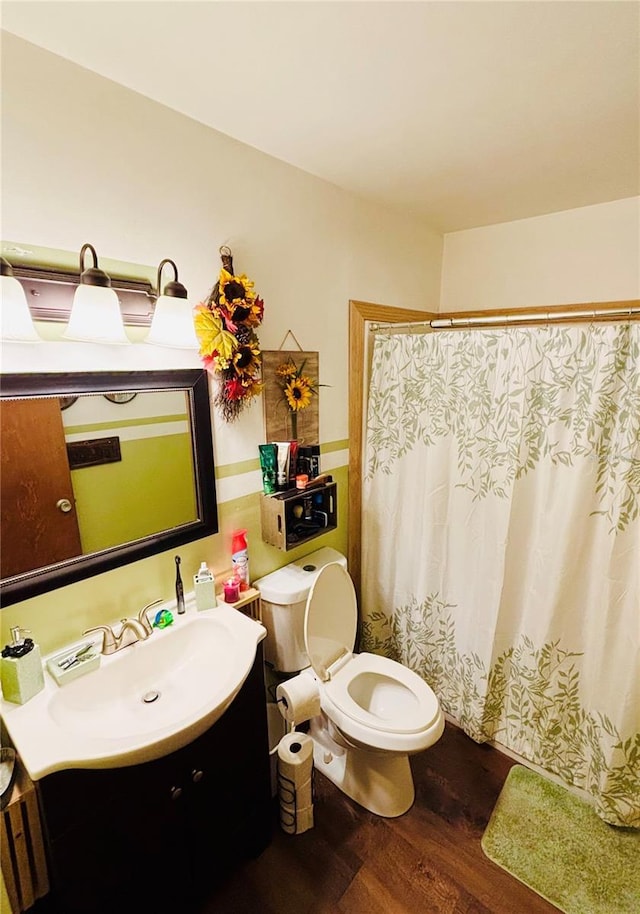 bathroom featuring vanity, a shower with curtain, toilet, and wood finished floors