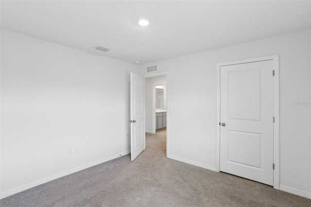 7530 Broad Pointe Dr, Zephyrhills, FL 33540 - unfurnished bedroom featuring light colored carpet and baseboards