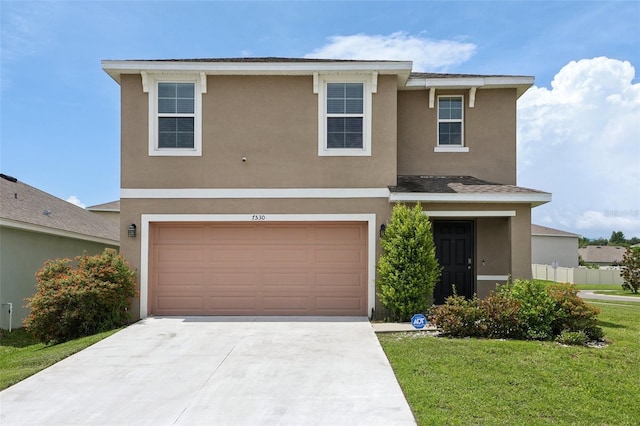 7530 Broad Pointe Dr, Zephyrhills, FL 33540 - traditional home with stucco siding, driveway, a garage, and a front lawn