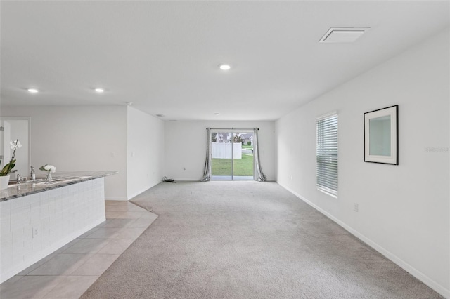 7530 Broad Pointe Dr, Zephyrhills, FL 33540 - unfurnished living room featuring light colored carpet and recessed lighting