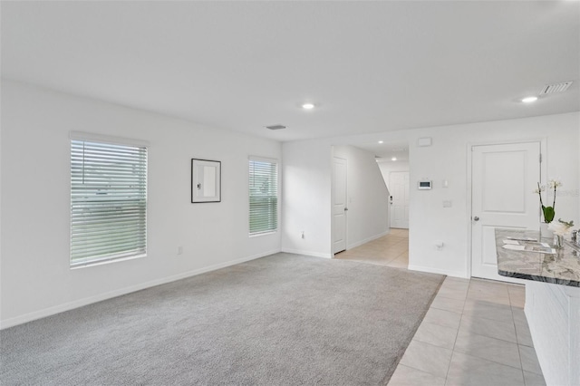 7530 Broad Pointe Dr, Zephyrhills, FL 33540 - unfurnished living room featuring light tile patterned floors and recessed lighting