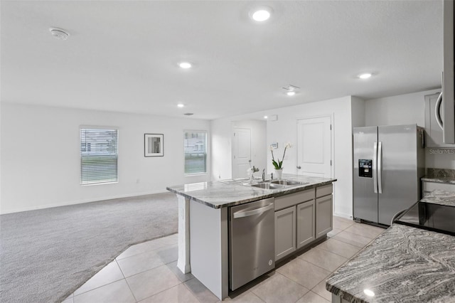 7530 Broad Pointe Dr, Zephyrhills, FL 33540 - kitchen featuring appliances with stainless steel finishes, light carpet, light tile patterned floors, plenty of natural light, and recessed lighting
