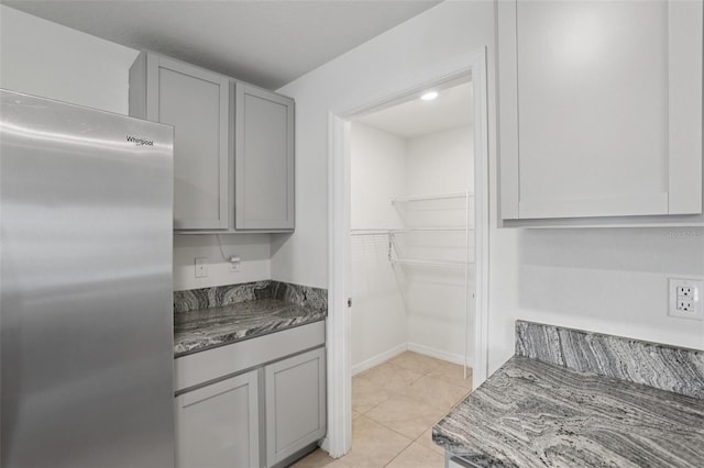 7530 Broad Pointe Dr, Zephyrhills, FL 33540 - kitchen featuring stainless steel fridge, gray cabinets, and light tile patterned flooring