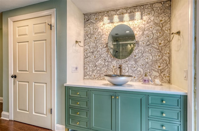 bathroom with vanity, baseboards, and wood finished floors